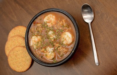 Cajun gumbo with crackers and a spoon.