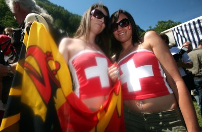 Two girls decorated with Swiss flags in Luzern, Switzerland