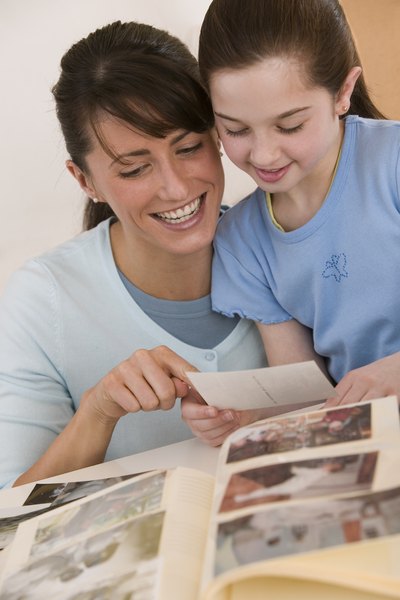 Mother and daughter looking at photo album