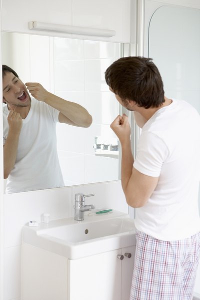 Man flossing teeth