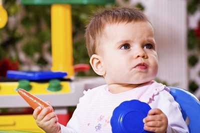 Young child playing in toy kitchen