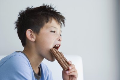 Boy eating a chocolate bar