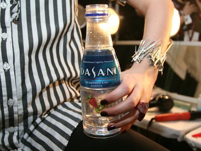 A model holds a bottle of Dasani water