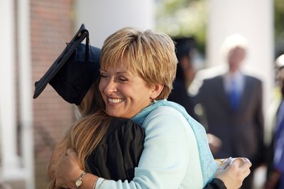 Mom hugging graduate