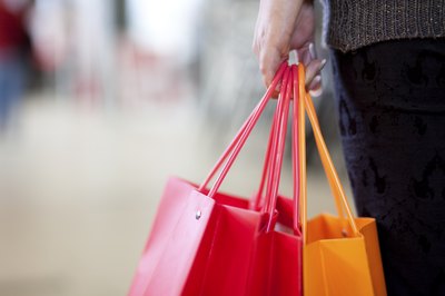 A woman is holding a gift bag in her hand.