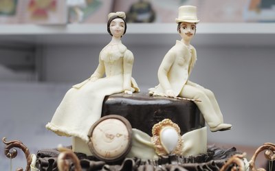 A close-up of antique wedding cake figurines.