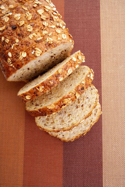 A loaf of wheat bread—and grains from which it is produced.