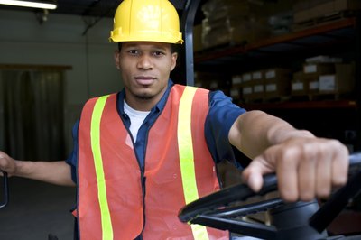 man driving cart in warehouse