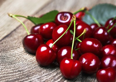 Close-up of cherries on wooden table top