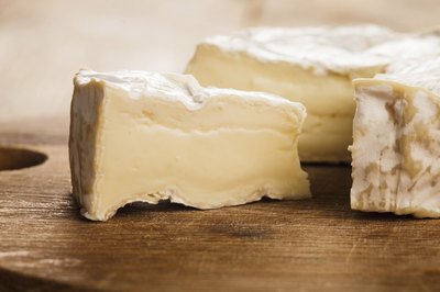 A close-up of a camembert cheese wedge.