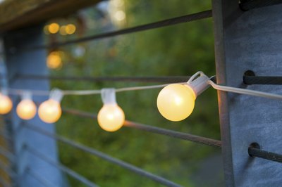 Strand of lights lit up on outdoor wall