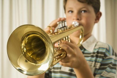 little boy playing the trumpet