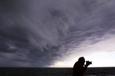 Photographer taking images of storm waves in Australia