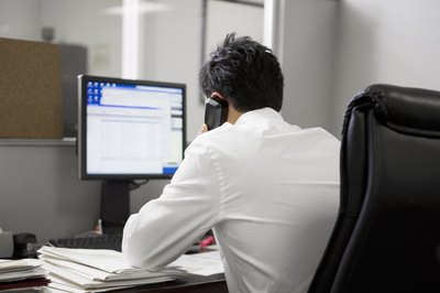 Sitting and working.