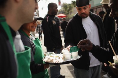 Starbucks coffee handed out to pedestrians for free in Harlem, NY.