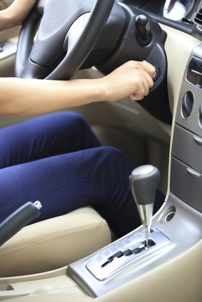 Woman turning car ignition key.