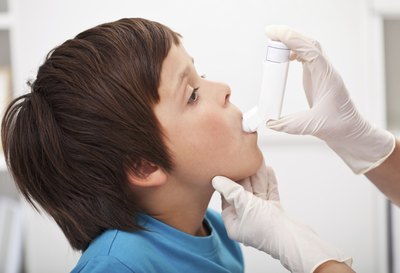 Young boy takes asthma medication