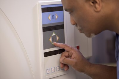 MRI technician operating machine