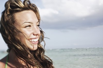 Teenage girl smiling at beach