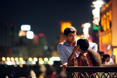 Couple talking by Dubai River in Dubai, UAE