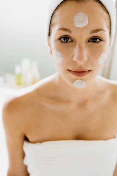 A woman using a spot treatment.