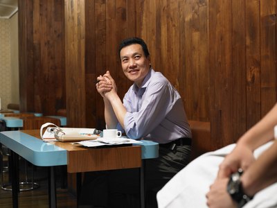 Manager sitting in restaurant going over paperwork