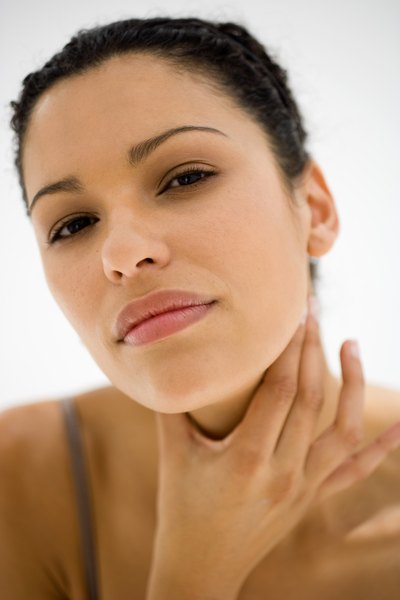 Woman examining her throat area