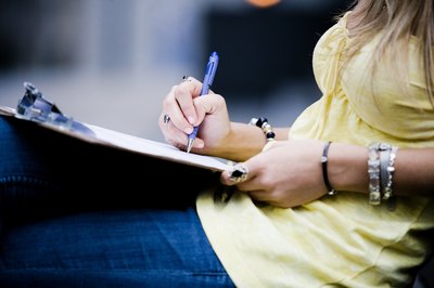 woman signing name on list