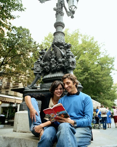 Two happy travelers look at a map together.