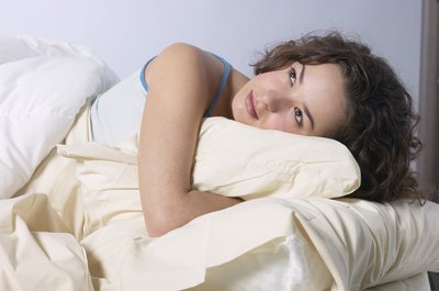 Woman waking up in bed