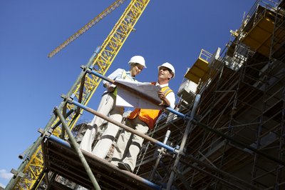 Construction supervisors on a scaffold platform