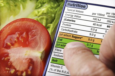 A man reads the nutritional label of a package.