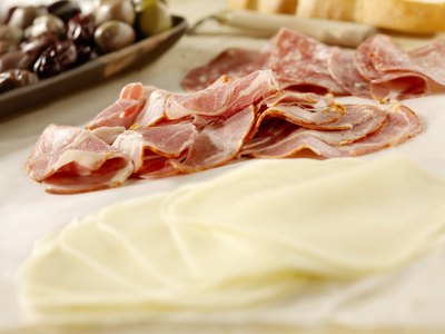 Slices of capicola with cheese and olives