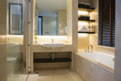 Lighting behind the vanity and shelves in a contemporary bathroom.