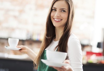 hipster woman carrying two cups of coffee