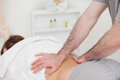 Physical therapist working on back.