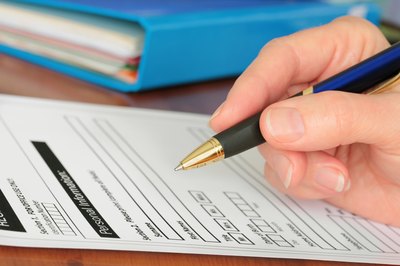 woman filling out paperwork for business license