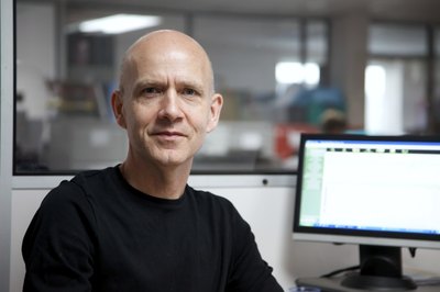 man sitting at desk with computer