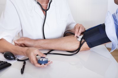 Nurse tests patient blood pressure
