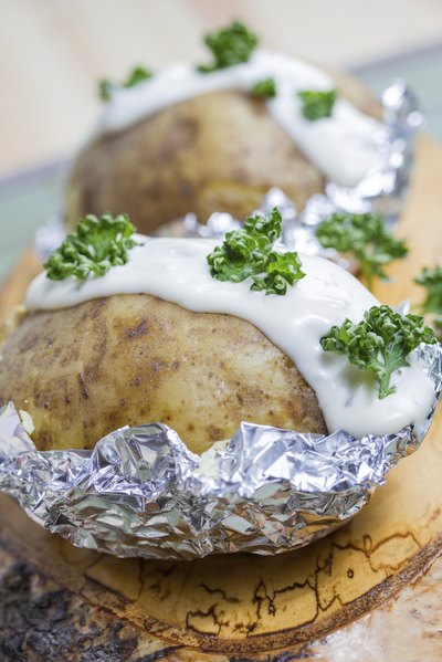 Baked potato with sour cream and parsley