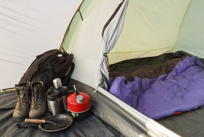 Assortment of camping gear next to tent