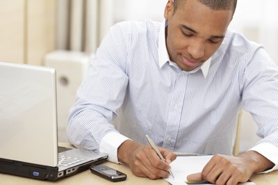 young man writing on a piece of paper
