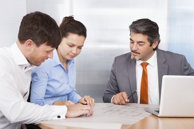 A married couple consults with a financial advisor.