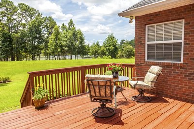 Pretty wooden porch built on to side of house.
