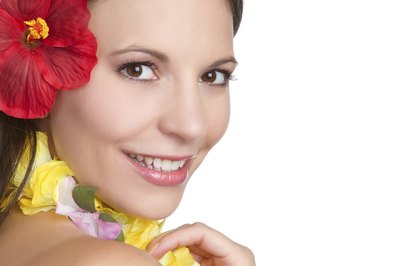 Smiling girl in Hawaiian attire.