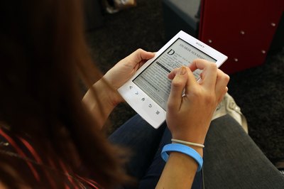 Purchase an audio book player or a portable book like Kindle.