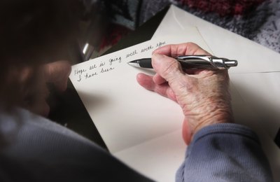 Senior citizen writing on new stationary