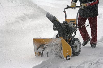 A man using a snowblower