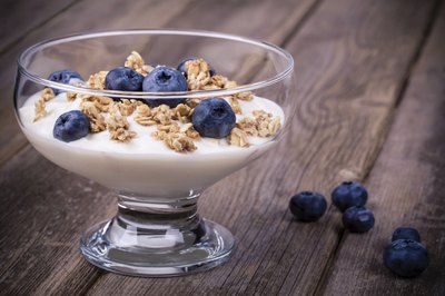 Dish of yogurt with granola and blueberries