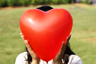 woman holding heart balloon